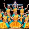 A Set Of Bharatnatyam dancer displaying a Classical Bharatnatyam Pose On Stage