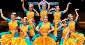 A Set Of Bharatnatyam dancer displaying a Classical Bharatnatyam Pose On Stage