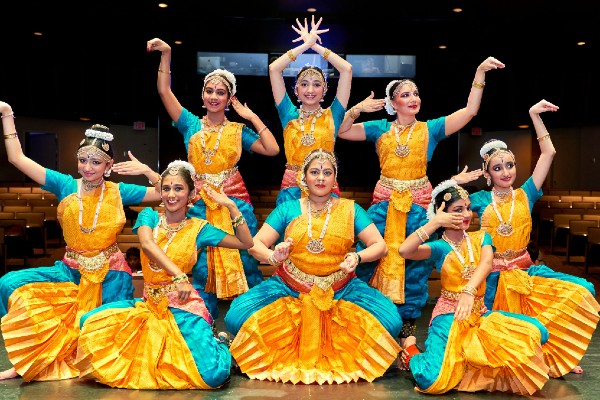 A Set Of Bharatnatyam dancer displaying a Classical Bharatnatyam Pose On Stage