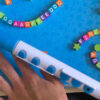 A musical instrument that has beads with alphabetic letters on its four sides, for kids.