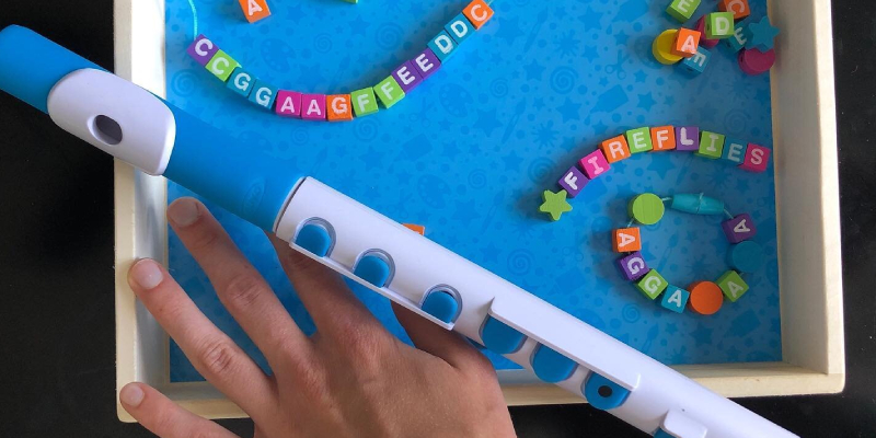 A musical instrument that has beads with alphabetic letters on its four sides, for kids.
